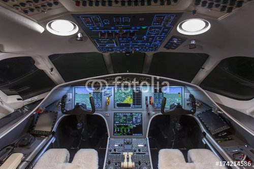Instrument panels in cockpit of a very modern private business jet at night 