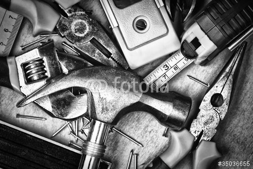 Set of tools over a wood panel on black and white - 901150435