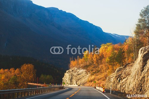 Beautiful vibrant fall autumn landscape of national park near border of Finland, Sweden and Norway, with mountains, camping place, road and forest