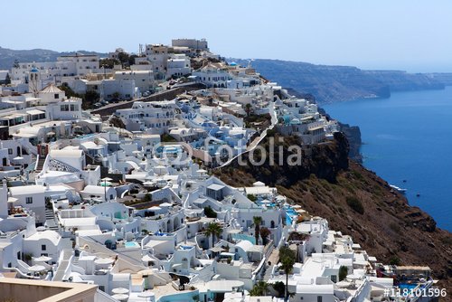 White houses and blue domes of Fira, Santorini at sunset