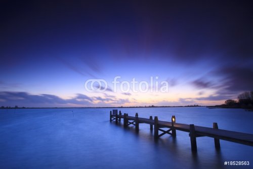 A tranquil sunset over a lake in the Netherlands - 900083455