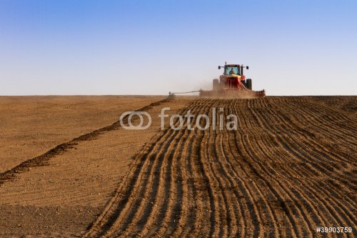 Agriculture tractor sowing seeds and cultivating field - 900366101