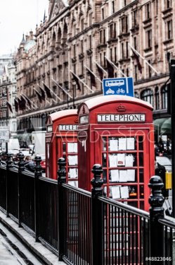 Classic red British telephone box in London - 901140379