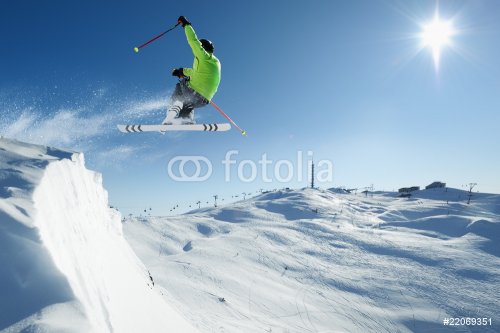 Jumping Skier in alpine mountains