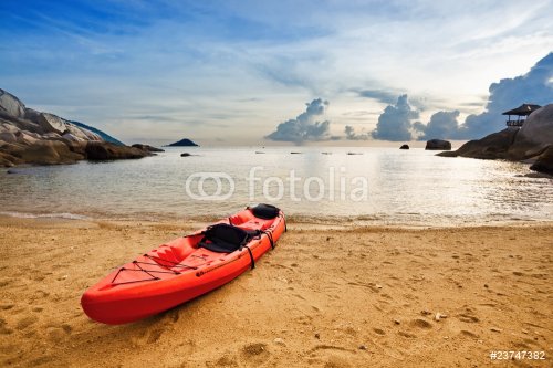 Lonely red kayak at the tropical beach in gloomy weather. - 900458198