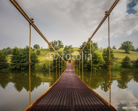 metal suspension bridge over the river - 901139990