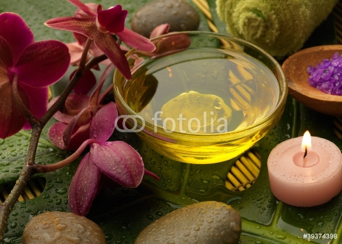oil and orchid with green leaf - 900634775