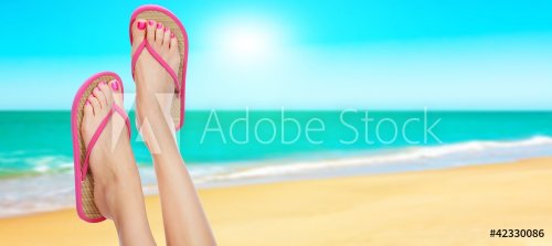 Pink sandals on woman legs. Summer time concept - 900452602