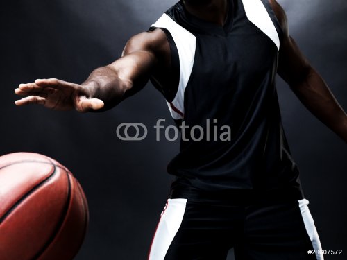 Professional basketball player in action against dark background