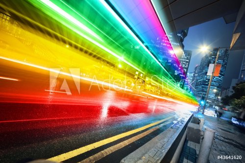 Rainbow spectrum blurred motion city bus at night