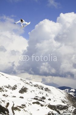 Snowboarder jumping high cloudy sky