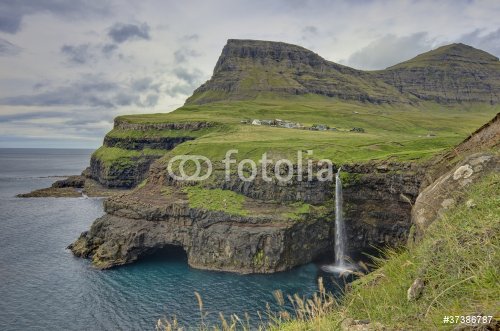 Steep green hills in the Faroe Islands - 900475860