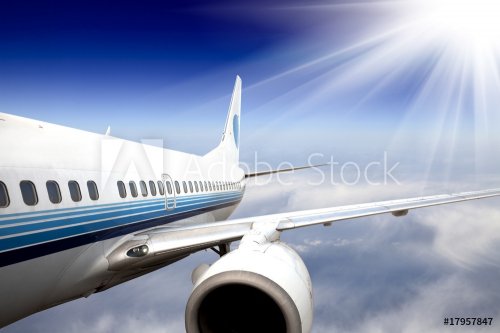 the airplane with the blue sky background. - 900063699