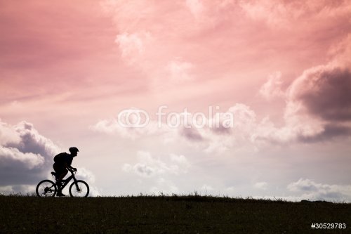 The Silhouette of mountain bike rider and sunset - 900458283
