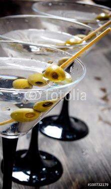 Three Martini with olives on a black table. - 901147303