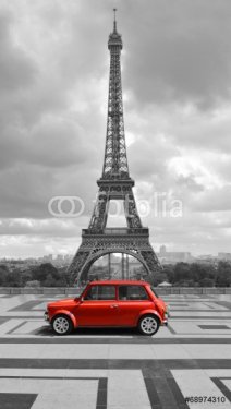 Eiffel tower with car. Black and white photo with red element.