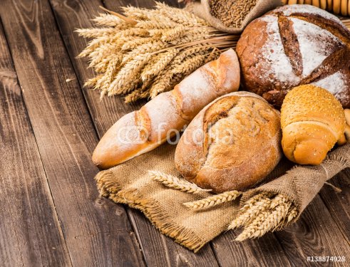 assortment of baked bread on wood table - 901152496