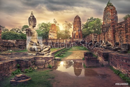 ancient Buddha statue and old Wat Mahathat pagoda in history temple of Ayutthaya Historical Park,world heritage sites of unesco.Vintage effect add for create atmosphere