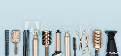 Hair stylist tools arranged in a line on blue background - 901155041