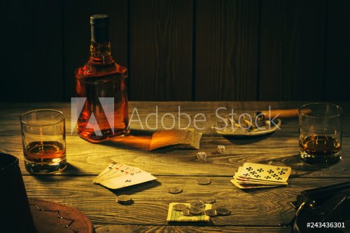 Table with playing cards, whiskey, cigar and weapons - 901155196