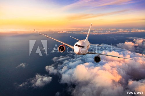 Passengers commercial airplane flying above clouds - 901155216