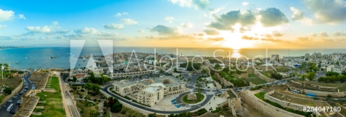 Aerial summer sunset view of Acco, Acre, Akko medieval old city with green roof Al Jazzar mosque and crusader palace, city walls, arab market, knights hall, crusader tunnels
