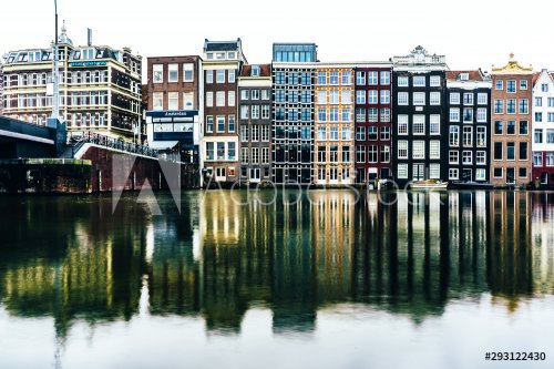 Cityscape with canal and houses in Amsterdam. Water surface with reflections ... - 901155432