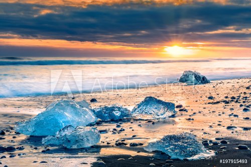 Drifting ice blocks on Diamond beach, at sunset, in Jokulsarlon, Iceland - 901155478