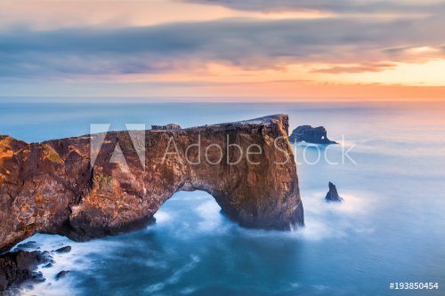 Dyrholaey rock formation at sunset. Dyrholaey is a promontory located on the south coast of Iceland, not far from the village Vik