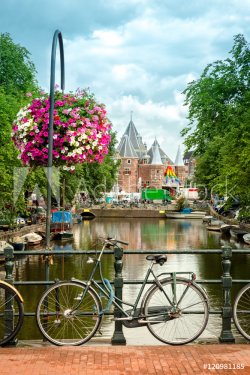 Typical Amsterdam view with bikes, canals and historical buildings. In the ba... - 901155482