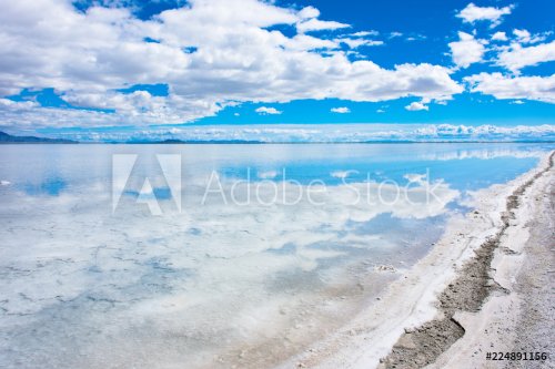 Flooded Bonneville Salt Flats in Utah create a mirror reflection scene on the water, looking surreal