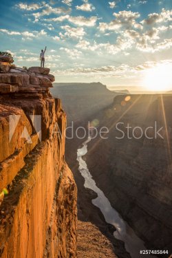 Hiker standing at edge of cliff of Toroweap Overlook, USA