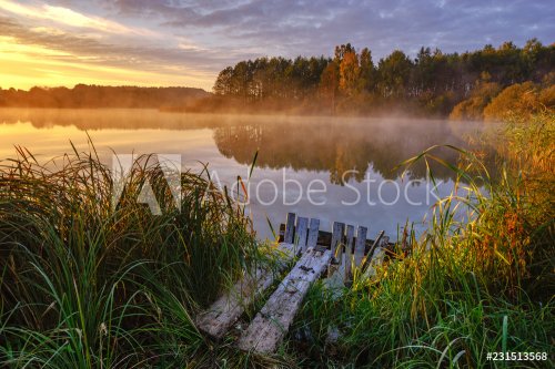 Levé de soleil brumeux et coloré sur le lac en Pologne