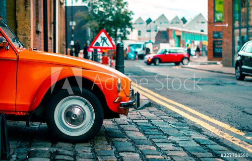 A Citroën Dyane leaves a parking garage driven by an old woman in Sheffield, UK