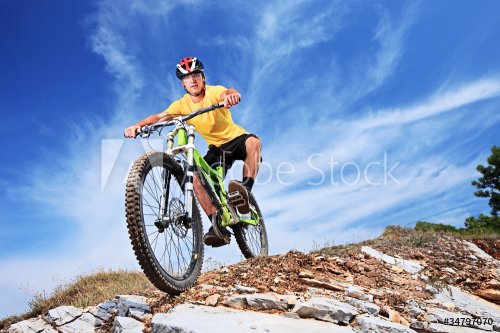 A young male riding a mountain bike - 900251206