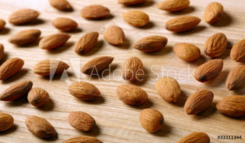 Almonds on wooden background