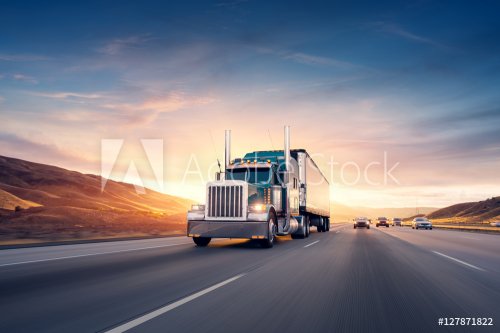American style truck on freeway pulling load. Transportation the