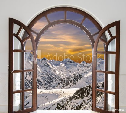 Arch door opened with views of the peaks of snowy mountains and