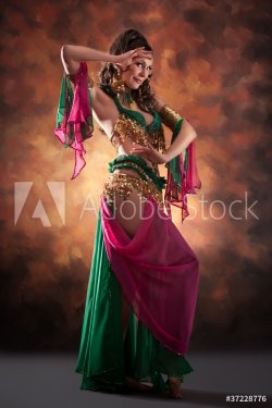 Beautiful exotic belly dancer woman a rot-green costume