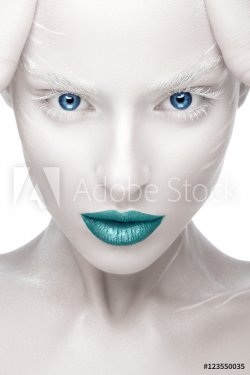 Beautiful girl in the image of albino with blue lips and white eyes. Art beauty face. Picture taken in the studio on a white background.