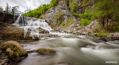 Beautiful landscape with waterfall among cliffs in spring time - 901144640