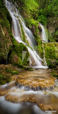 Beautiful waterfall among cliffs in spring time - 901144631