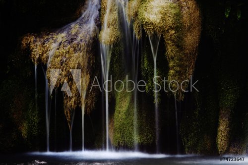 Beautiful waterfalls on the river following from a cave - 901144264