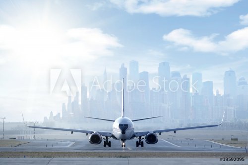 Big aircraft on runway in big city