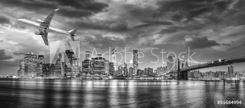 Black and white view of airplane overflying New York City