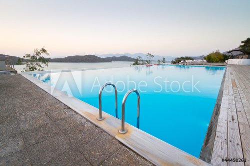 Blue swimming pool with Mirabello Bay view on Crete, Greece - 900648464