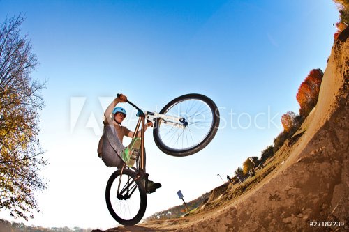 boy going airborne with his  bike