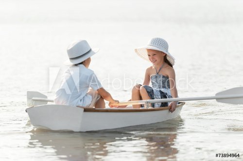 Boy with a girl riding on a boat - 901144119