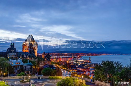 Cityscape or skyline of Chateau Frontenac, park and old town streets during sunset with illuminated castle, Espace 400e building
