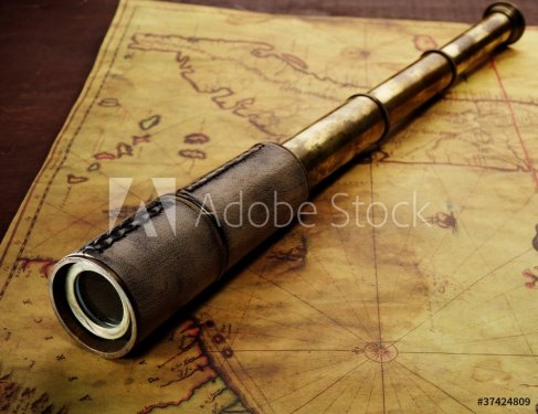 Close-up of a spyglass on the old map - 901138021